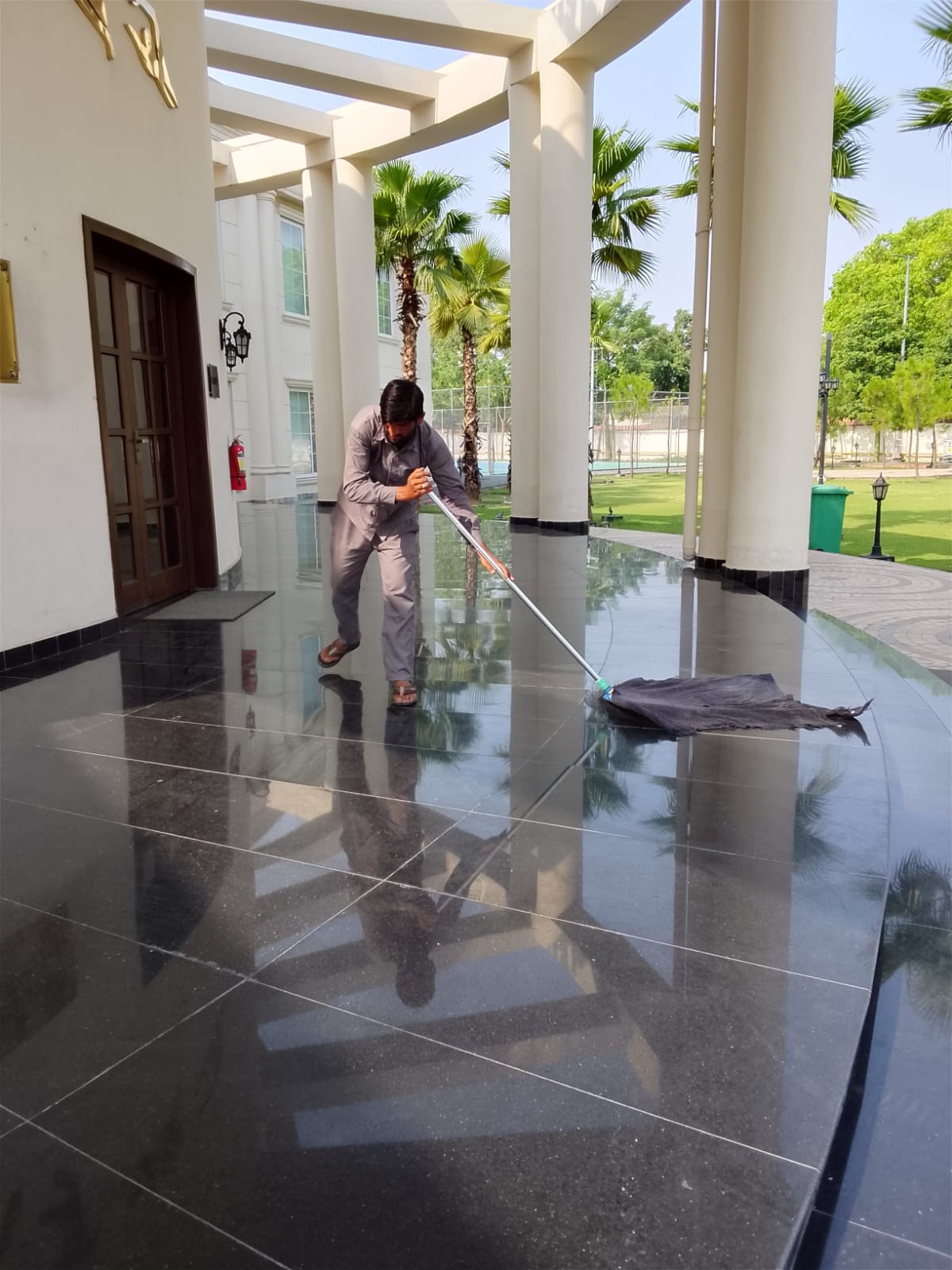 EHAS worker carrying out floor cleaning at a commercial facility